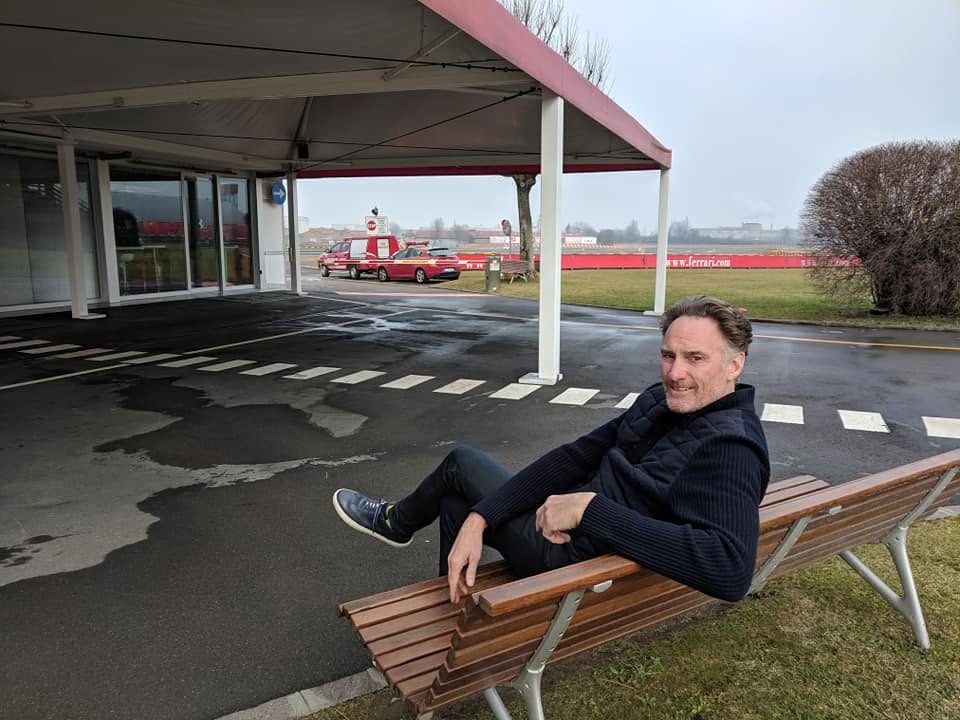 Sitting on a bench at an airfield